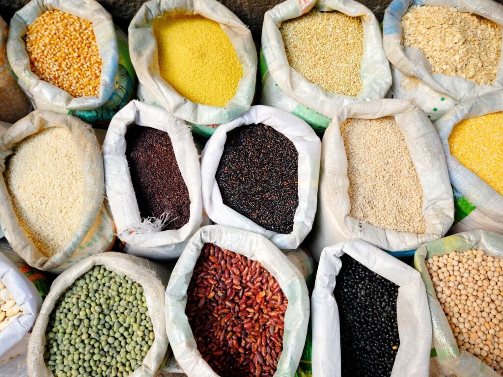 Open sacks of lentils, beans, seeds and grains seen from above
